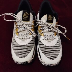 Curry Black, White And Some Gold Sneakers.